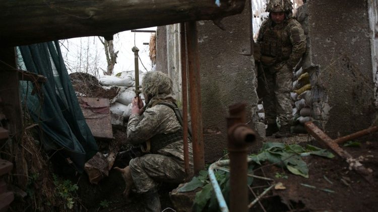 Ukrainian soldiers keep watch on the frontline between themselves and Russian-backed separatists