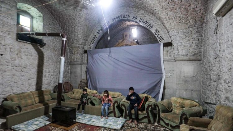 Children seek shelter in an abandoned church in al-Yaqubiya town in Syria's Idlib province. 