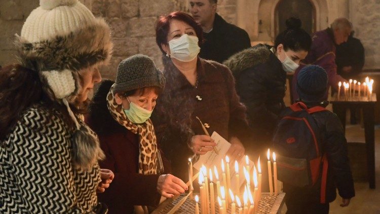 Syrian faithful light candles in the Armenian Orthodox Church in Aleppo