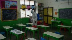 A health worker disinfects a classroom in Mumbai, India, ahead of reopening after Covid-19 closure. 