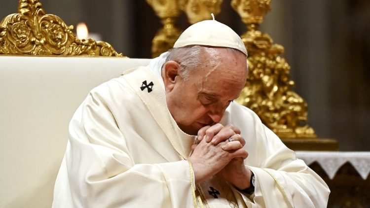 File photo of Pope Francis with his head bowed in prayer