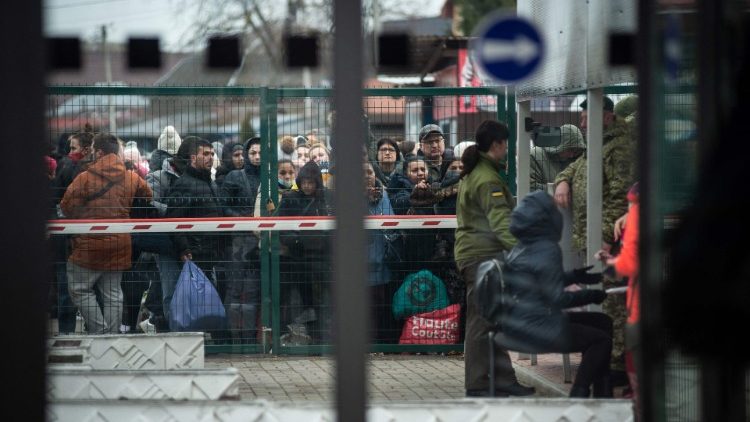 Ukrainians wait at the Slovak-Ukrainian border crossing in Velke Slemence, Slovakia