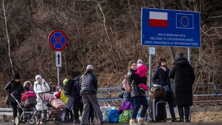 Refugees from Ukraine are seen as they arrive at the Polish-Slovakian border crossing in Kroscienko, Poland