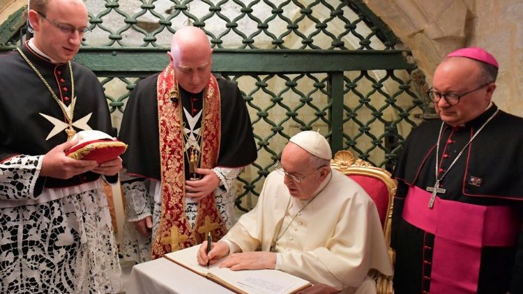 Pope Francis signing the Book of Honor in St. Paul's Grotto in Rabat, Malta