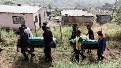 Coffins are carried to a Church after a prayer at the destroyed home of a family in Hammersdale in KwaZulu Natal