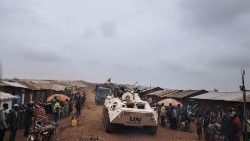 A UN armoured vehicle escorts a truck in northeastern Democratic Republic of Congo