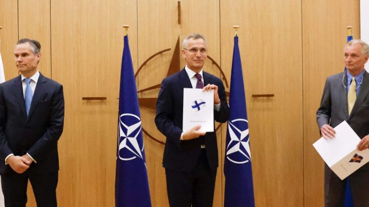 Finland's Ambassador to NATO, Klaus Korhonen; NATO Secretary-General Jens Stoltenberg; and Sweden's Ambassador to NATO, Axel Wernhoff, attend a ceremony to mark Sweden's and Finland's application for membership