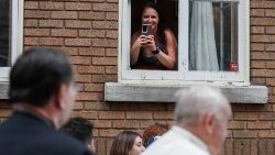 A woman records a video of Pope Francis in Quebec