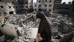 Una donna palestinese tra le macerie di Gaza City