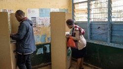 Voters mark their ballots in a booth during Kenya's general elections