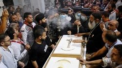 Worshipers hold a funeral for those who died in the deadly blaze