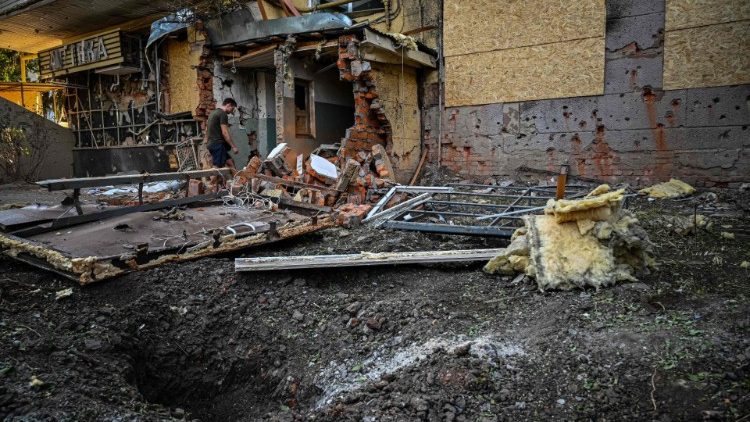 A man walks through the rubble of a damaged building following a shelling on Kharkiv, Ukraine