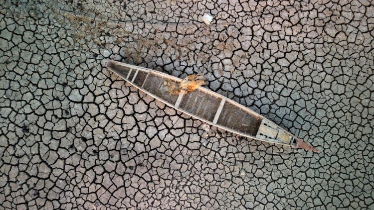 A boat on the dried-up bed of one of Iraq's receding southern marshes of Chibayish. Heatwaves and worsening drought are displacing millions of people in the Middle East.