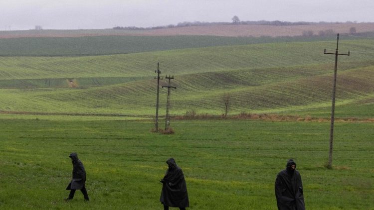 Police investigators are seen during a searching patrol in the fields near the site where a missile strike killed two men in a village in eastern Poland