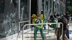 Rioters destroy a window of the supreme court in Brasilia