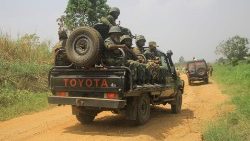 Soldiers from the national army escort civilian vehicles transporting goods in the Democratic Republic of Congo