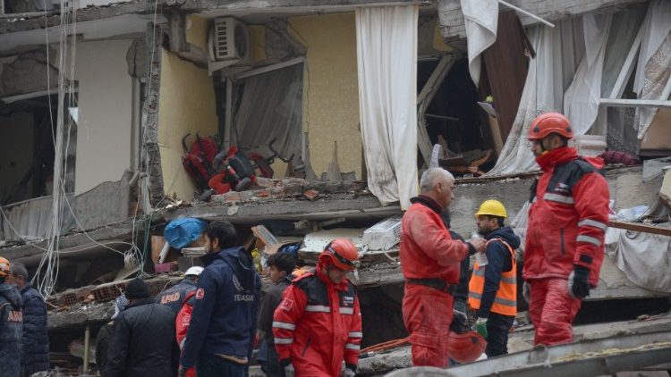 Rescue workers and volunteers in the rubble of a collapsed building in Diyarbakir in south-east Turkey