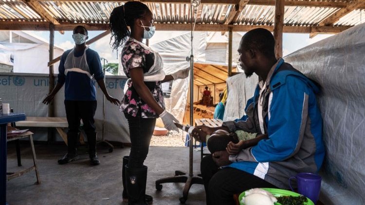 A healthcare worker tends to a new patient at a temporary cholera treatment center in a Lilongwe hospital