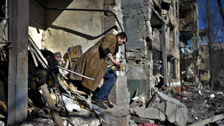 Mieszkaniec Kramatorska w obwodzie donieckim, niedaleko linii frontu, szuka swoich rzeczy po rosyjskim ostrzale budynku mieszkalnego, 14 marca 2023