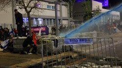 Israeli security forces use water cannons to disperse protestors during demonstrations in Tel Aviv