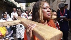 Pilger tragen ein Holzkreuz auf der Via Dolorosa (Leidensweg) in der Jerusalemer Altstadt während der katholischen Karfreitagsprozession am 7. April 2023.