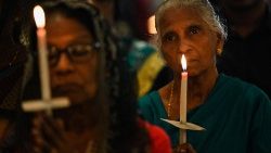 Catholics hold candles while praying at St. Anthony's church in Colombo on Easter Sunday , April 9, 2023