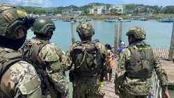 Ecuadorean Navy guard a port where nine people were killed