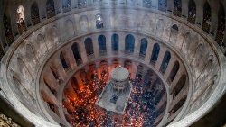 File photo showing Orthodox Christians gathering around the Edicule with lit candles during the Holy Fire ceremony at Jerusalem's Church of the Holy Sepulchre