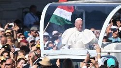 Sur cette photo prise le 12 septembre 2021, le Pape François fait un tour dans un véhicule ouvert pour saluer les fidèles avant une messe à la fin d'un congrès eucharistique international à Budapest. 