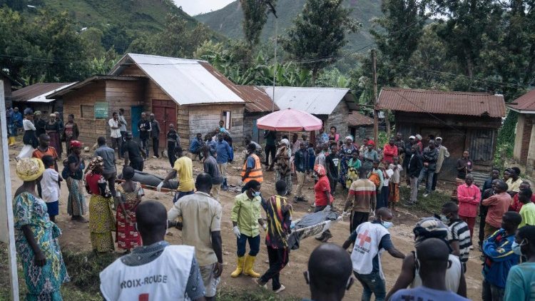 Voluntários da Cruz Vermelha Congolesa e residentes de Nyamukubi carregam os corpos de pessoas que morreram em fortes enchentes no leste da República Democrática do Congo, em 6 de maio de 2023.