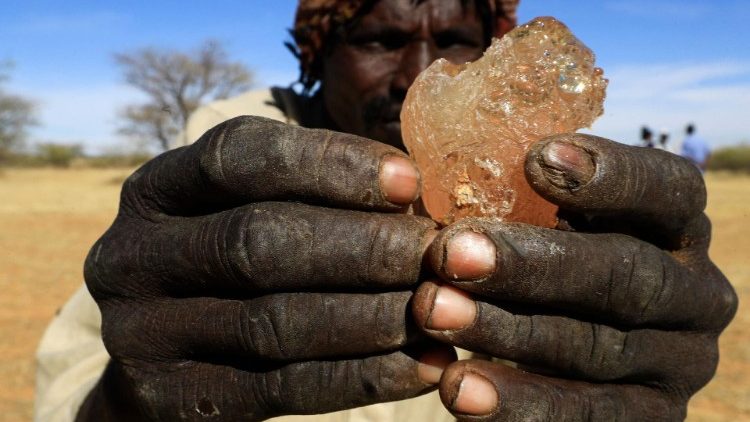 A farmer in war-ravaged Sudan shows gum arabic resin
