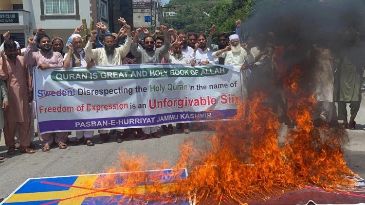Protesters burn a Swedish flag during a demonstration in Muzaffarabad 