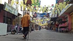 A man walks past closed shops in Ain al-Helweh