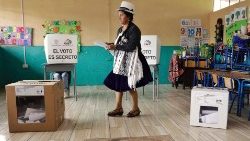 An indigenous woman casts her vote in Ecuador's elections