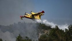 A Canadair drops water over wildfires in northern Greece