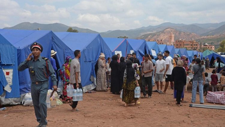 People displaced by the earthquake in Morocco gather at a shelter camp. 