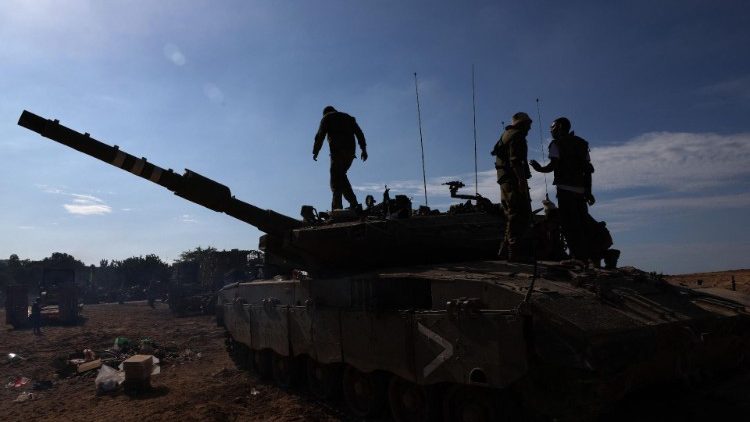 Israeli soldiers are positioned outside kibbutz Beeri near the border with the Gaza Strip.