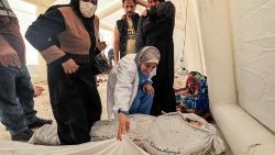 Lidé v Gaze se pokoušejí identifikovat oběti útoku na nemocnici al-Ahli Arabi