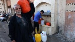  People fetch water from a fountain in Rafah in the southern Gaza Strip on 20 October 2023.