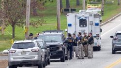 Members of the FBI Evidence Response Team and State Police gather at the site of a mass shooting in Lewiston