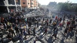 Palestinians search rubble for survivors following Israeli strikes on al-Maghazi refugee camp in the Gaza Strip