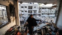 Palestina no prédio destruído do jornalista Adel Zorob, morto durante a noite em um bombardeio israelense, em Rafah, no sul da Faixa de Gaza, em 19 de dezembro. (Photo by MAHMUD HAMS / AFP)