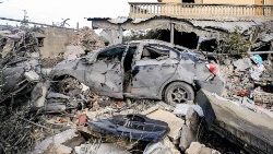 A destroyed vehicle amidst rubble following strikes on the town of Naqura in southern Lebanon