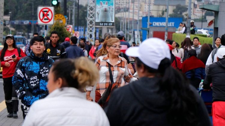 Pessoas caminham na rua no centro de Quito em 9 de janeiro de 2024, em meio à crescente tensão no país andino (AFP)