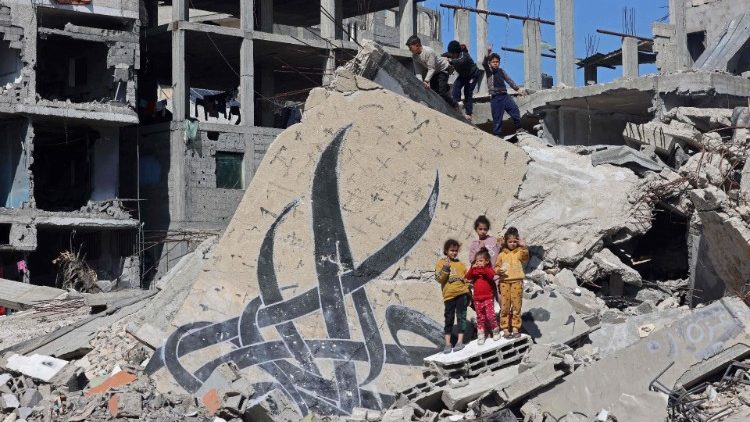Children amongst the rubble of a destroyed building in Rafah