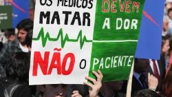 A demonstrater holds up a sign reading "Doctors should kill pain, not the patient" during a protest last year against efforts to legalize euthanasia in Portugal