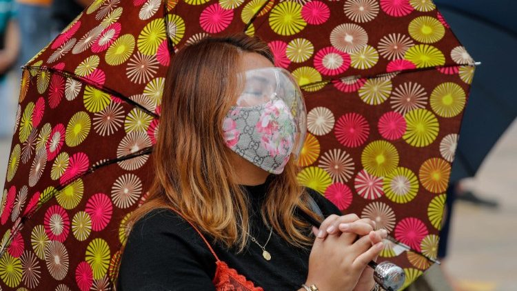A woman prays while attending a recent Catholic festival