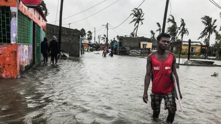 A man wades through flood water in the city of Beira, Mozambique
