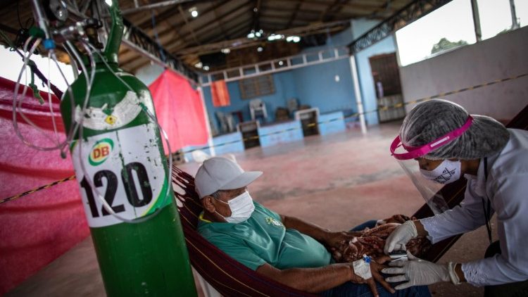 A nurse performs a coronavirus test on a man from an indigenous community in Brazil