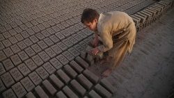 Criança afegã trabalhando na produção de tijolos no distrito de Nangarhar